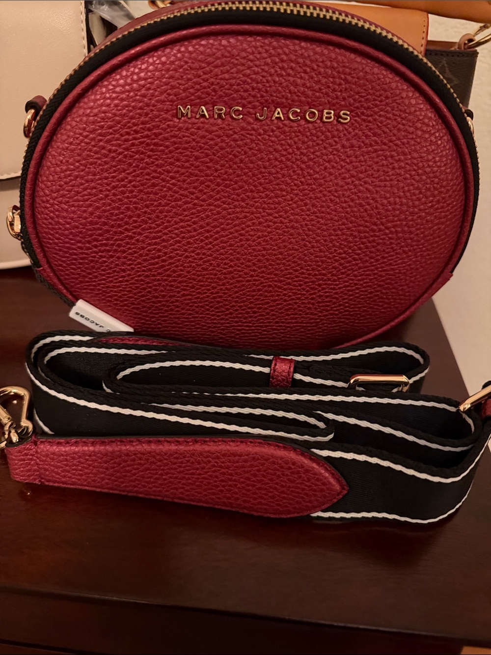 Marc Jacobs Pebbled Round Crossbody in Deep Red with Black-White Strap